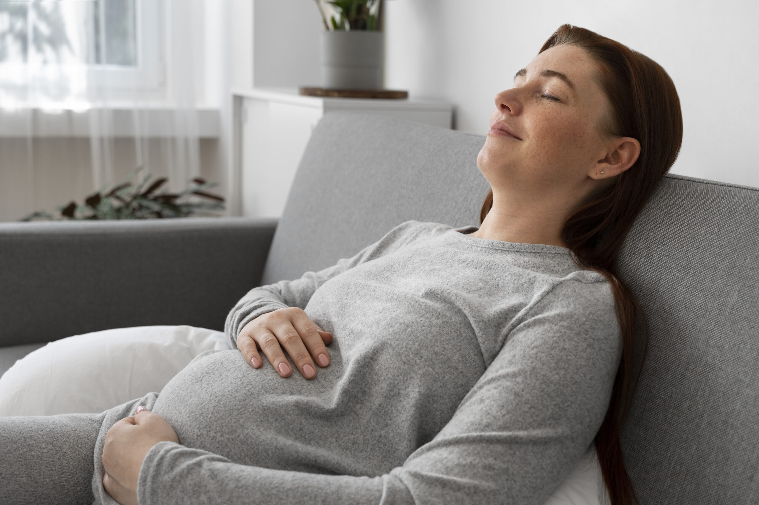 Side view pregnant woman laying home